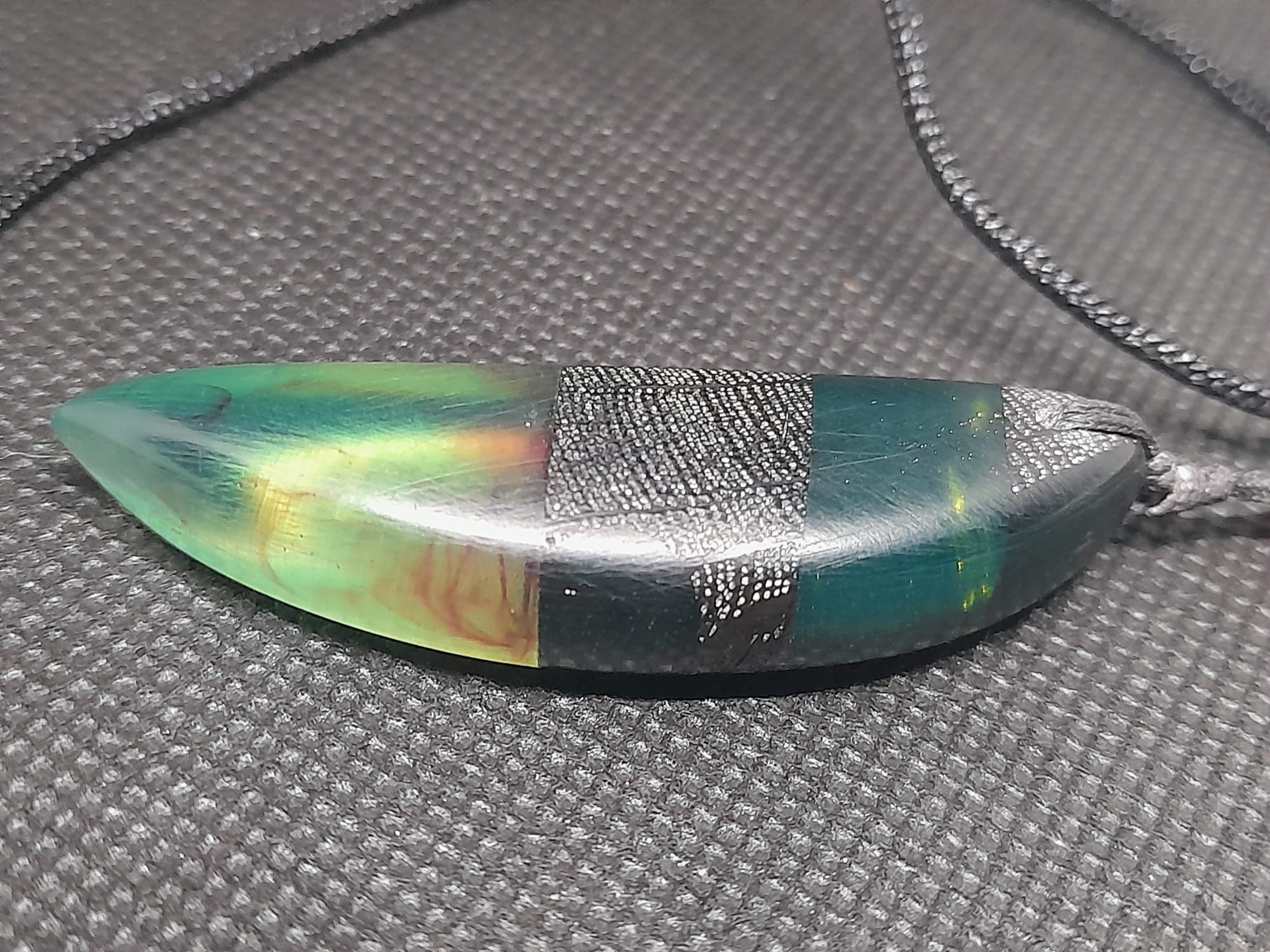 Blue green resin and bog oak teardrop pendant with red accent on titanium-plated chain